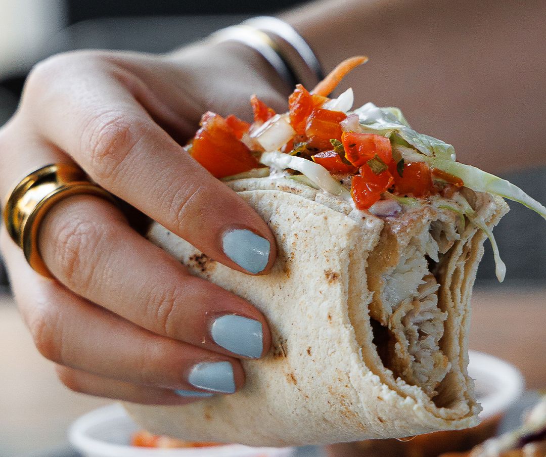 Battered fish taco, fully dressed with salsa